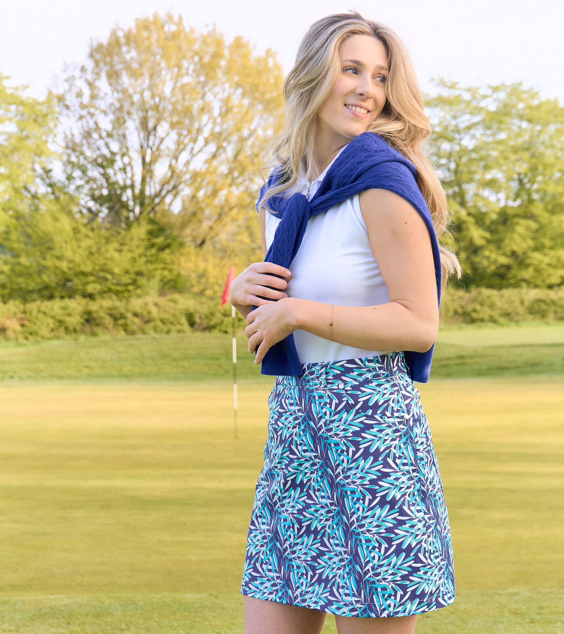 Model wearing Pure Golf Floating Palms Yale colourway summer outfit on the golf course – stylish ladies pure golf clothing from Ladies Online Golf
